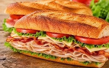 toasted sub with thin slices of turkey & bacon with lettuce, tomatoes & cheese.